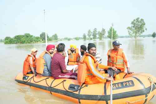 Riding boat, Punjab CM visits flood-hit areas