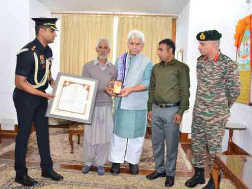 J&K L-G hands over Sarvottam Jeevan Raksha Padak to father of martyr